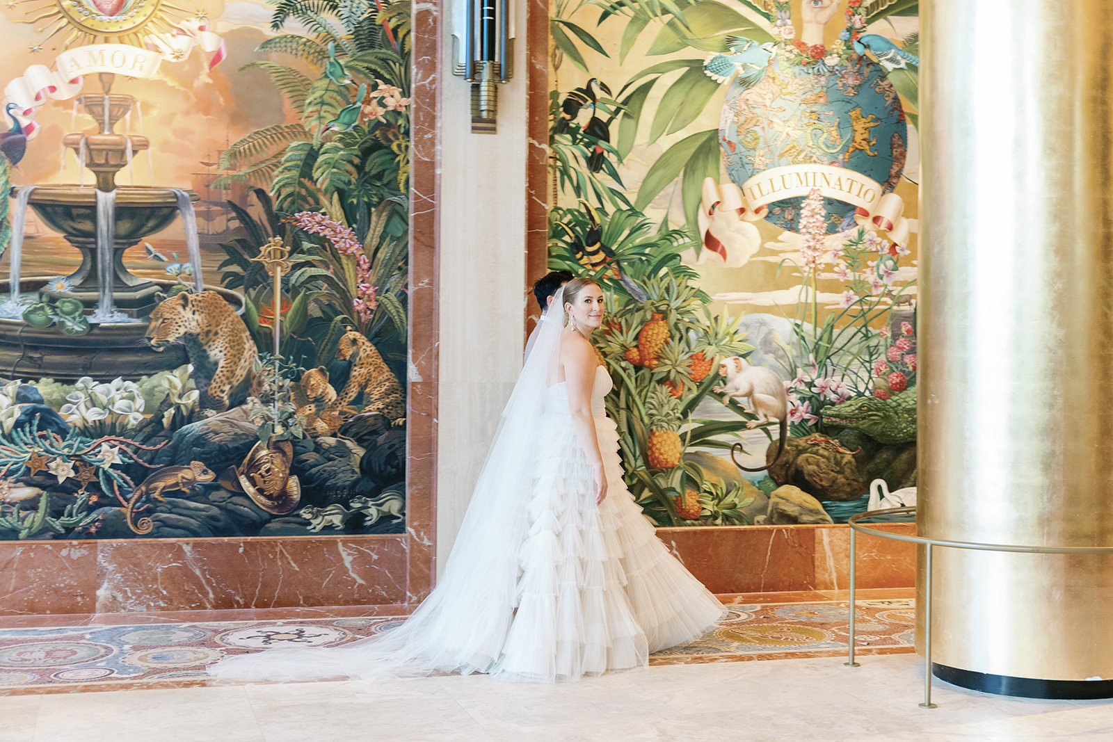 Bride in a layered wedding gown standing inside Faena Hotel Miami Beach lobby