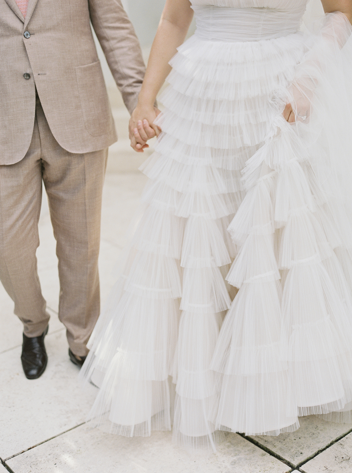 Close-up detail of bride’s layered tulle wedding dress during portraits