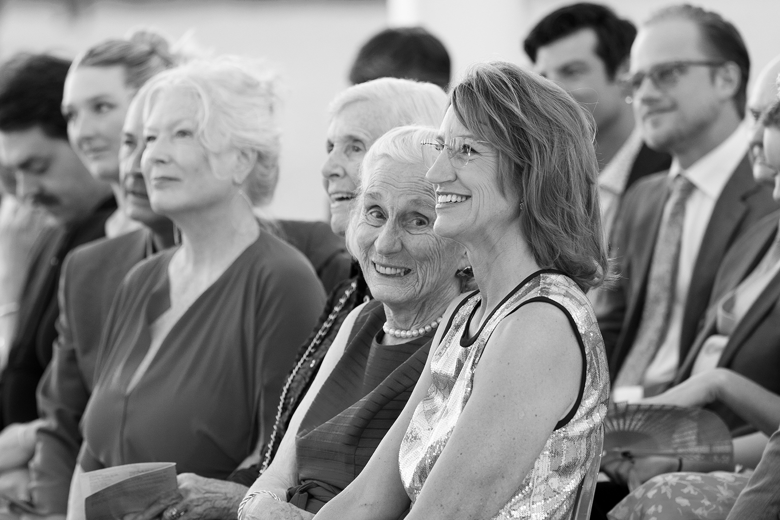 Close-up of wedding guests smiling and reacting emotionally during the ceremony