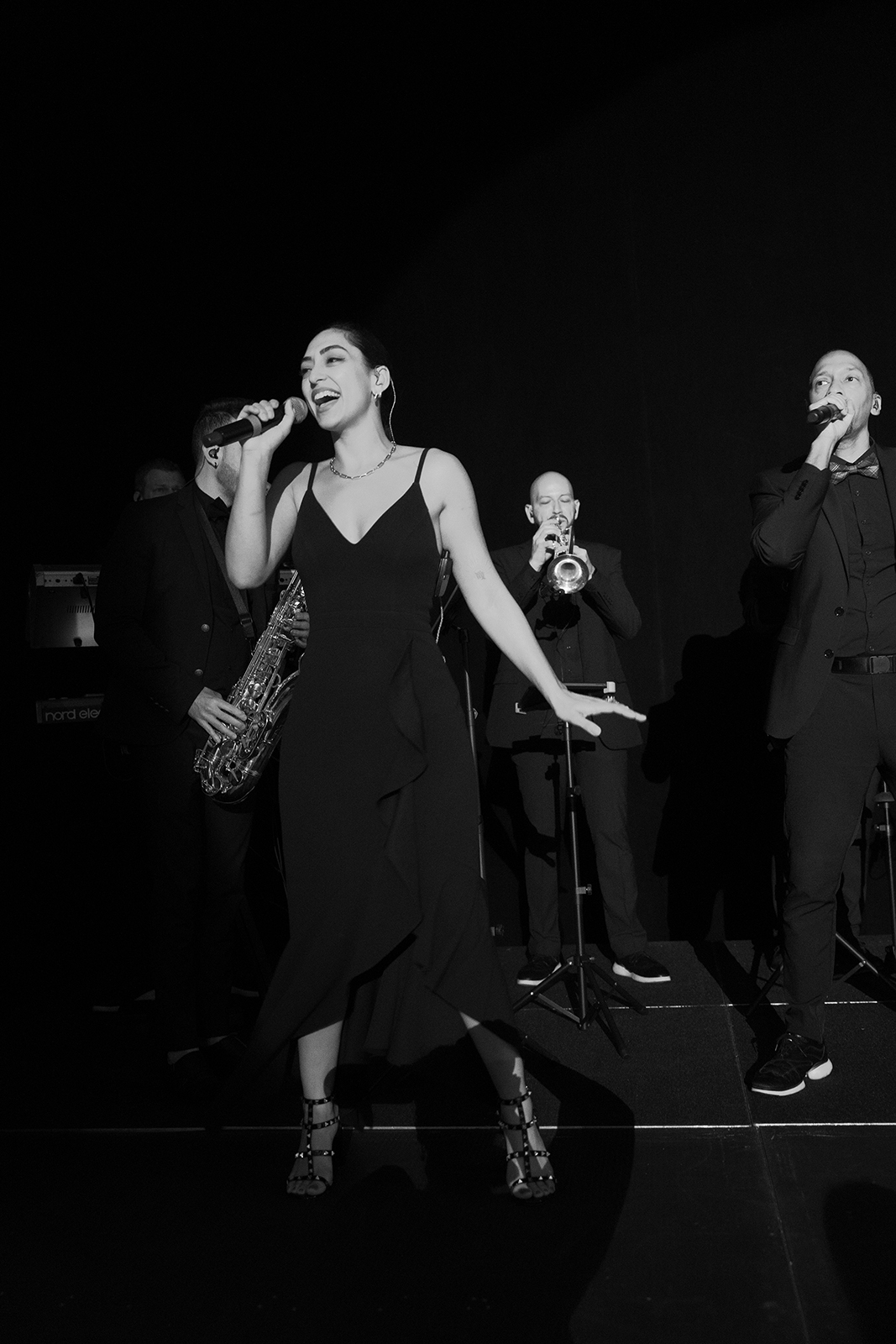 Lead singer and band performing live music during an energetic wedding reception