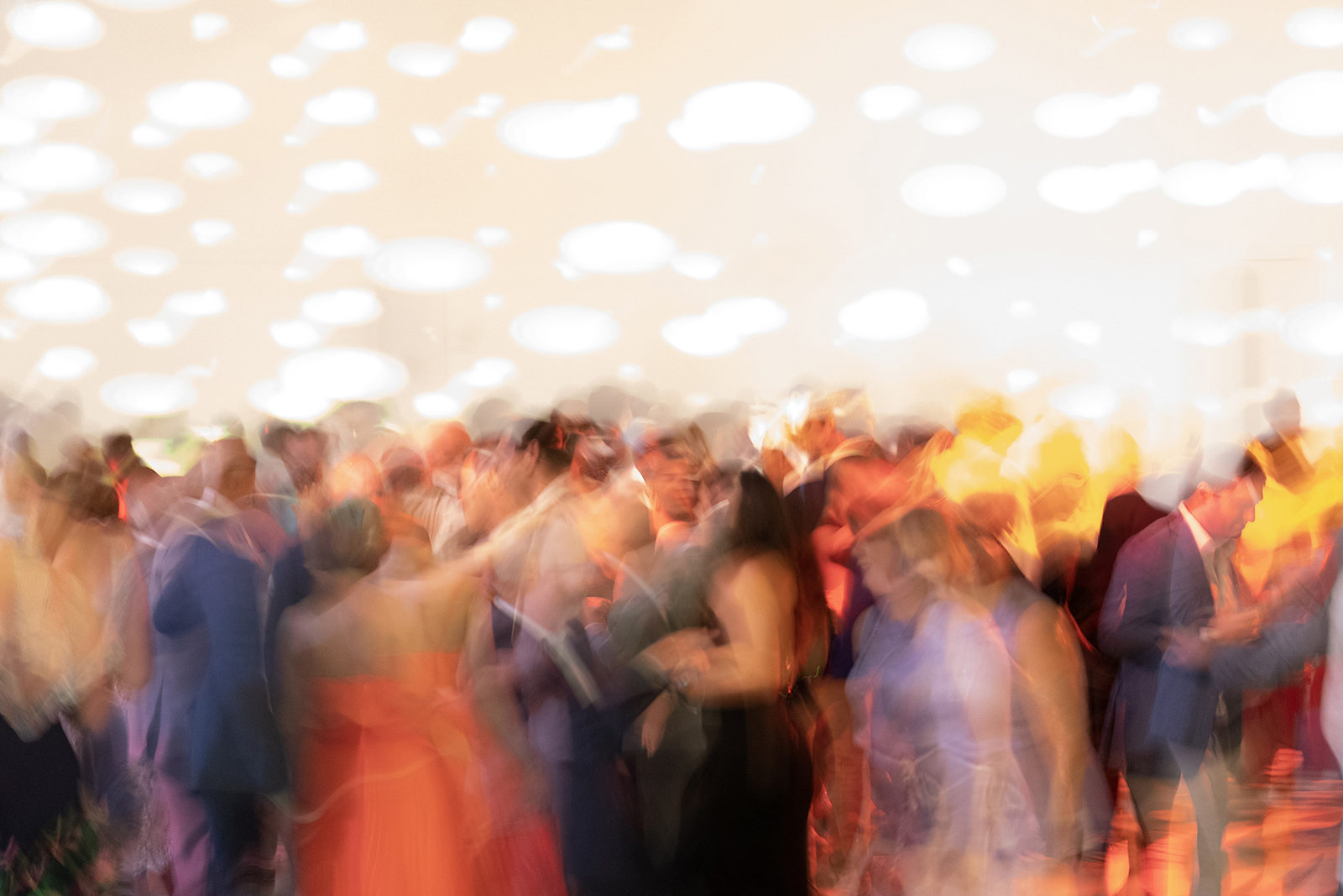 Abstract motion blur of wedding guests dancing on a crowded dance floor