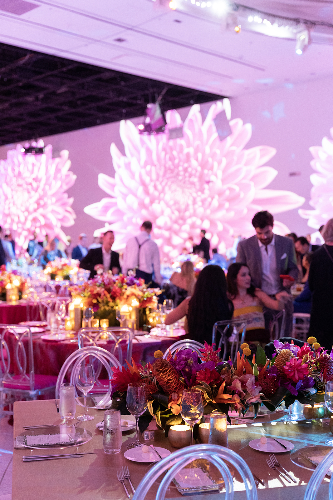 Elegant wedding reception at Faena Miami Beach with candlelit tables, lush floral centerpieces, and signature pink lighting.