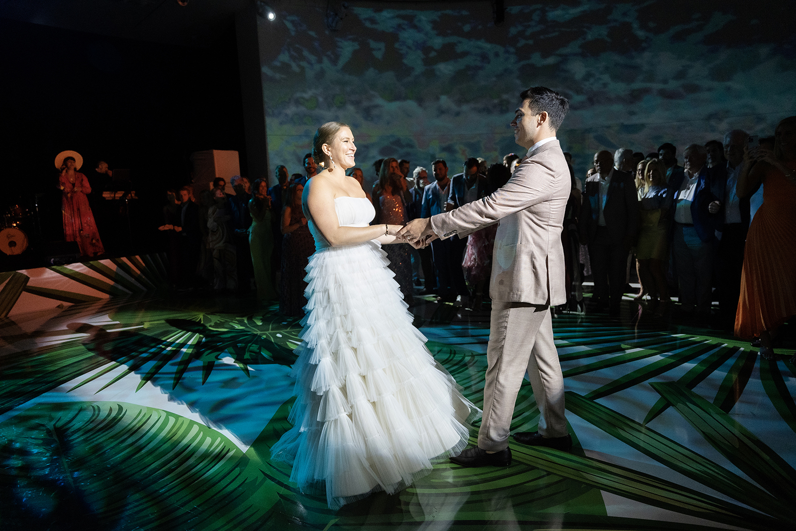 Bride and groom dancing together on the Faena Miami Beach dance floor, surrounded by guests and immersive lighting.