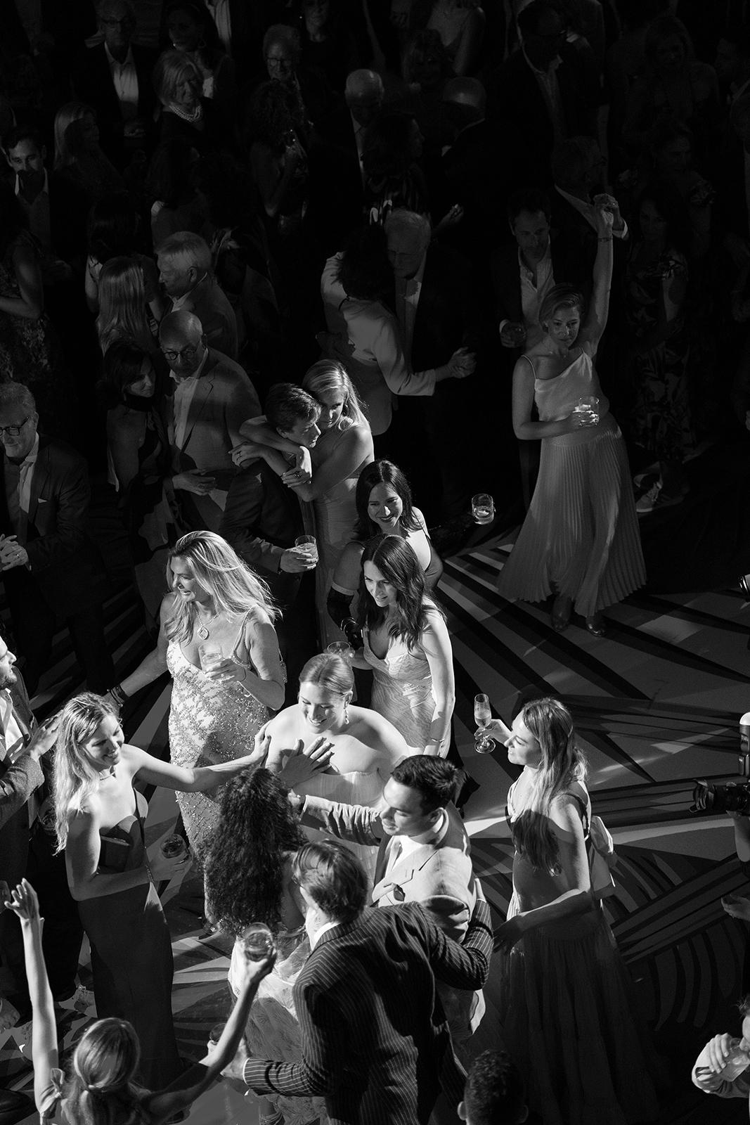 Black and white aerial view of guests dancing at a high-energy Miami Beach wedding celebration.