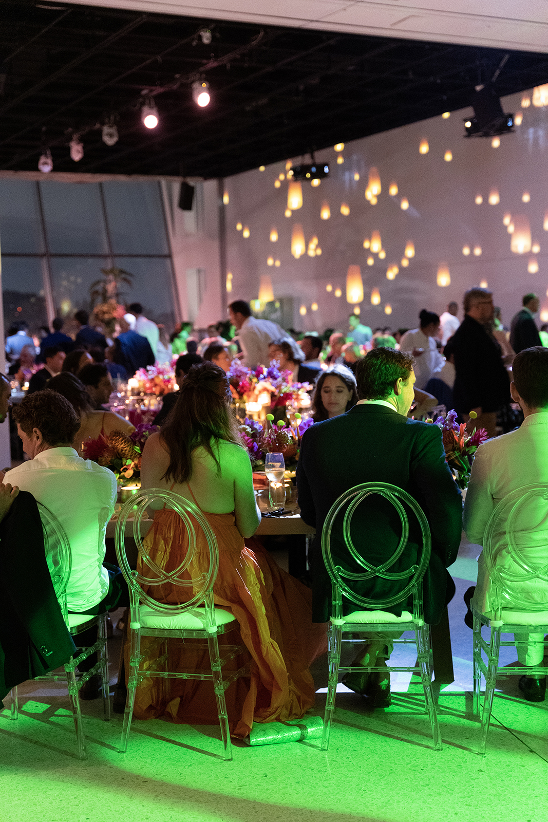 Guests seated at beautifully styled tables during a wedding reception with ambient lighting