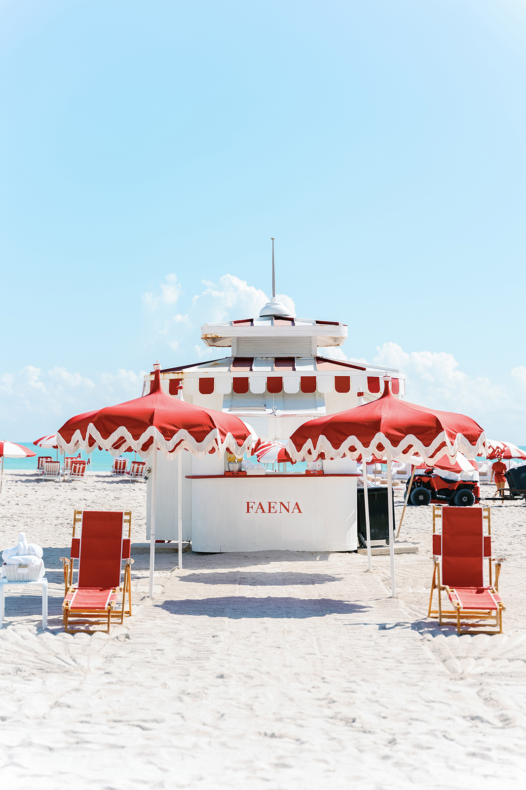 Faena Beach Club setup with red and white umbrellas on Miami Beach during a luxury destination wedding weekend