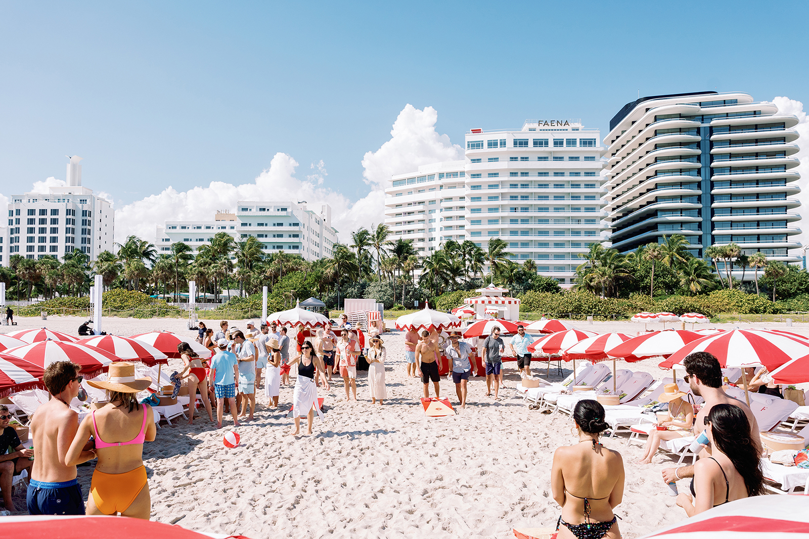 Wide view of guests gathered on the beach during a destination wedding welcome party in Faena