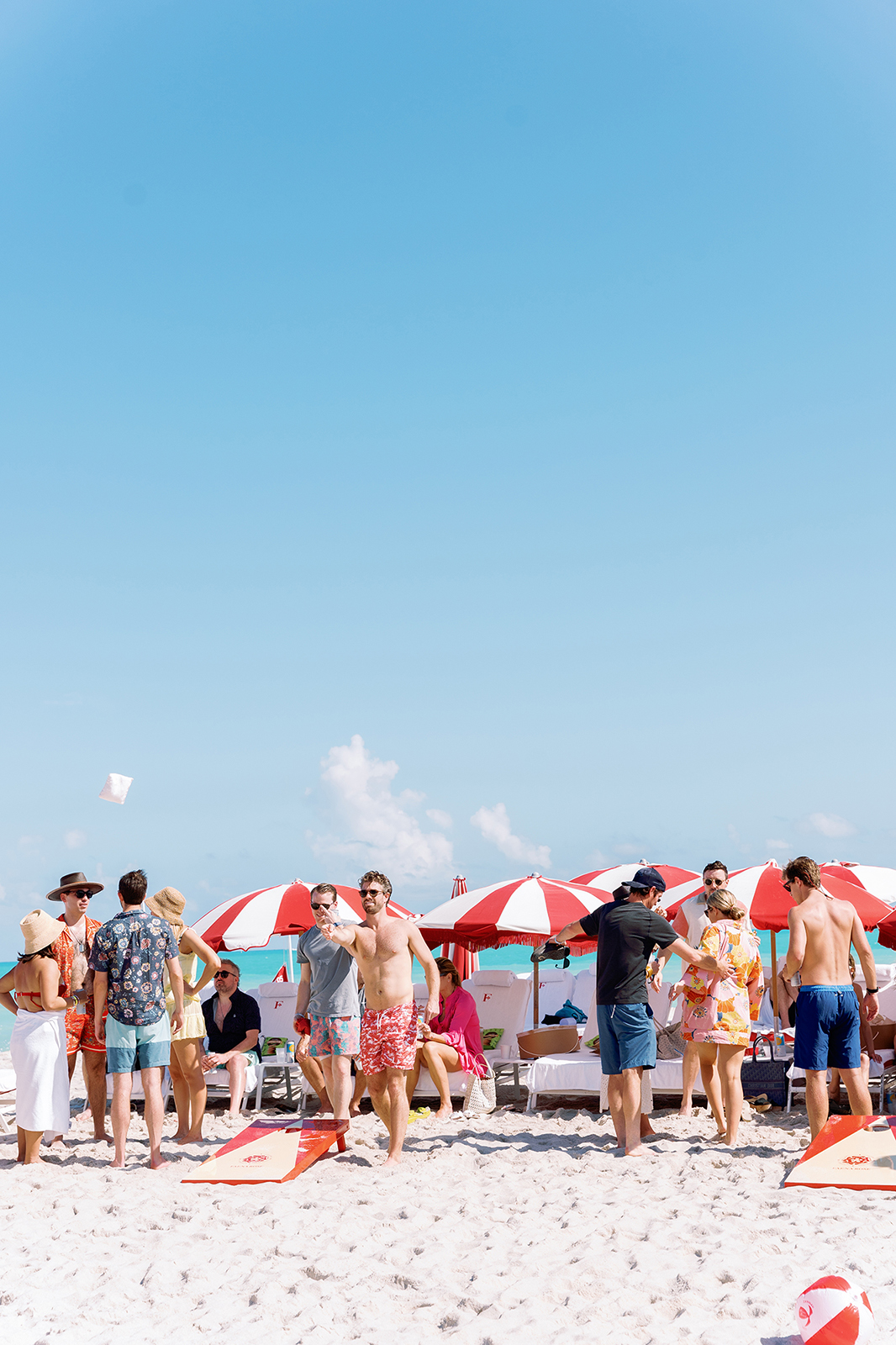 Wedding guests playing beach games and socializing during a destination wedding celebration