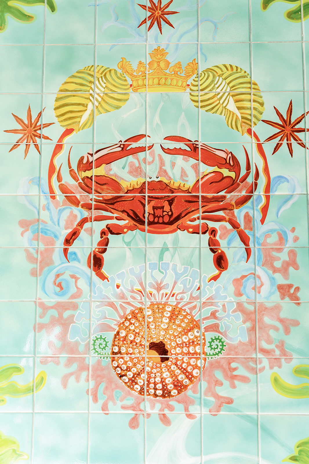 Iconic Faena tile mural with crowned crab and coastal imagery