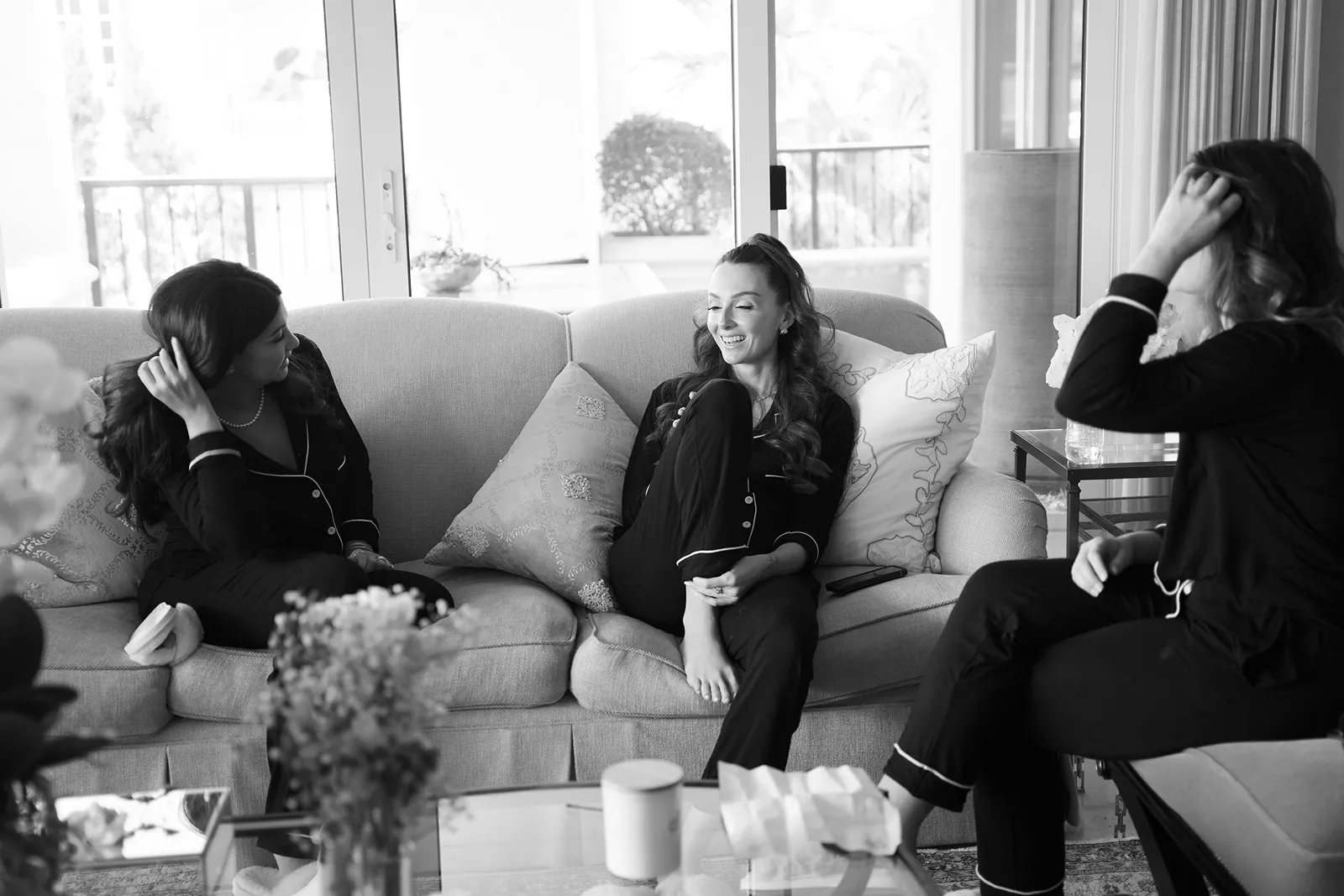 Bridesmaids relaxing and laughing together while getting ready for a luxury wedding