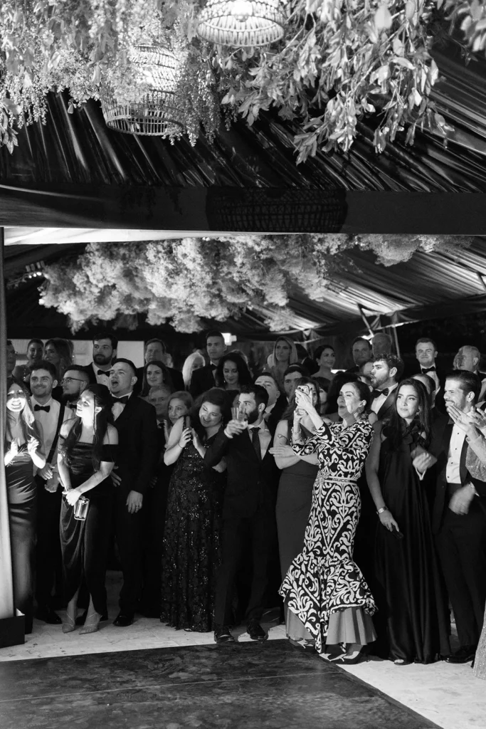 Wedding guests gathered around the dance floor during an elegant Fisher Island wedding reception