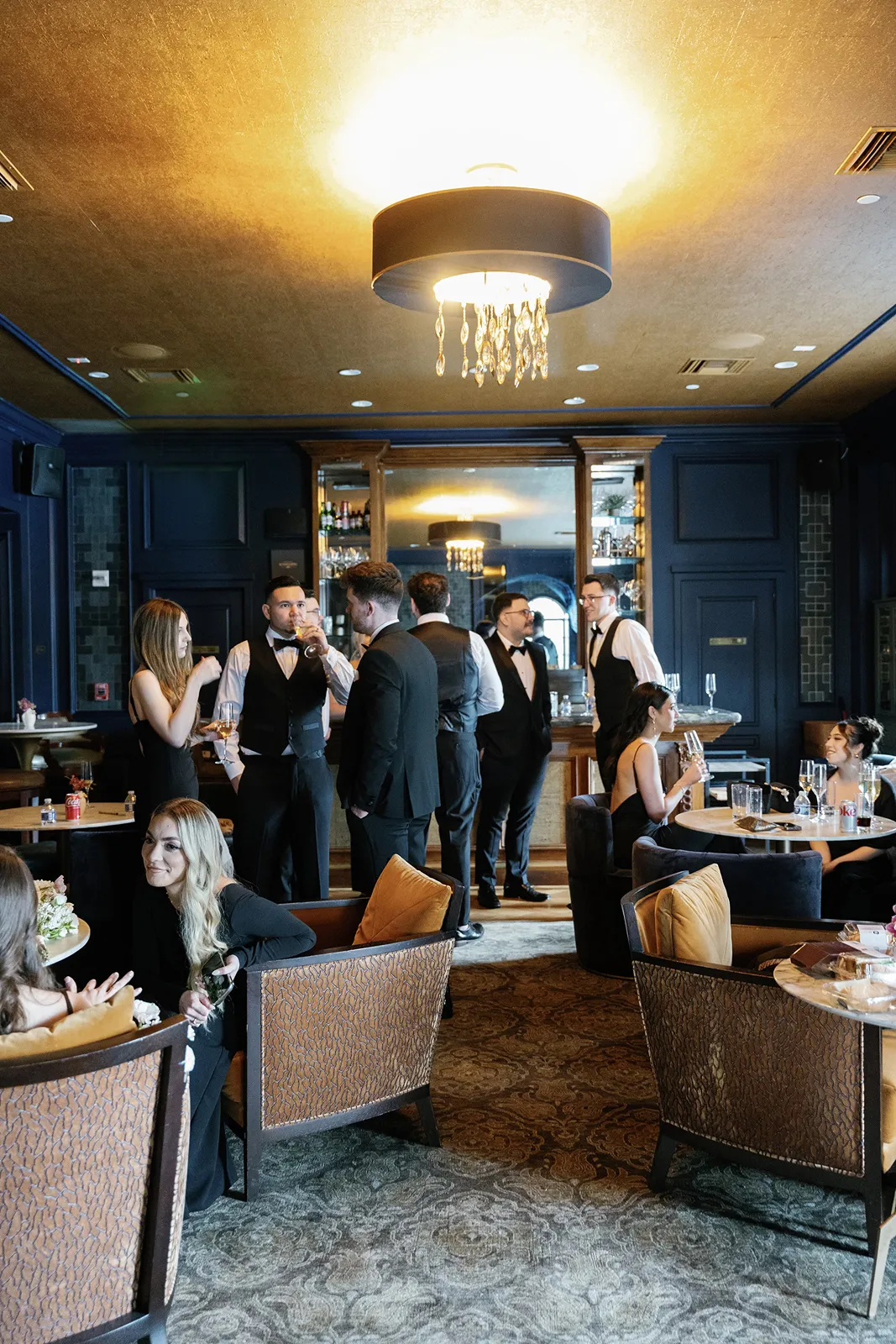 Wedding guests socializing inside the Fisher Island Club lounge before the reception