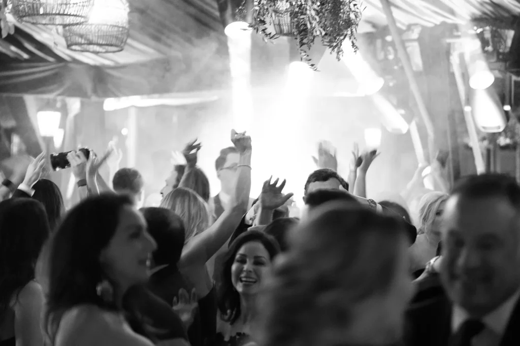 Wedding guests dancing during a lively black-tie reception at a Fisher Island wedding in Miami