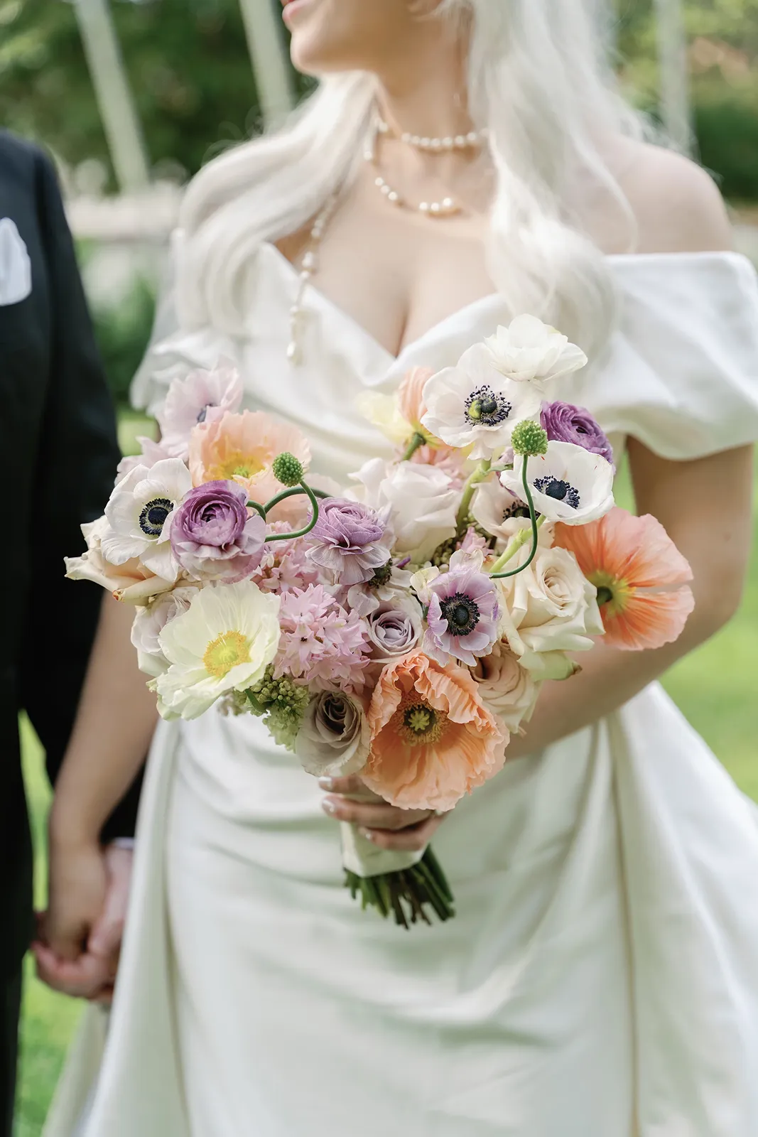 Bride holding a pastel spring bouquet during a Fisher Island wedding portrait