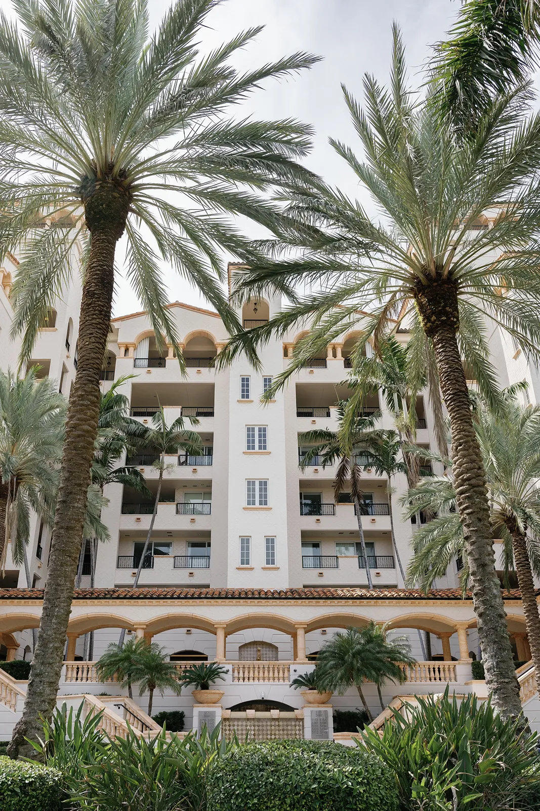 Fisher Island Club wedding venue exterior with palm trees and Mediterranean-style architecture