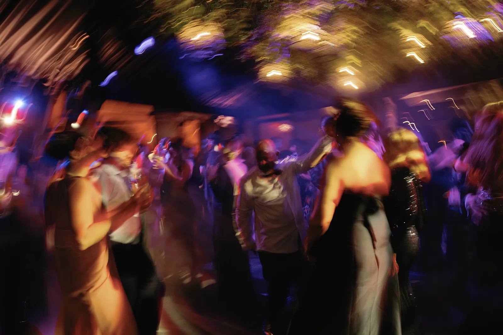 Guests dancing during a high-energy wedding after party