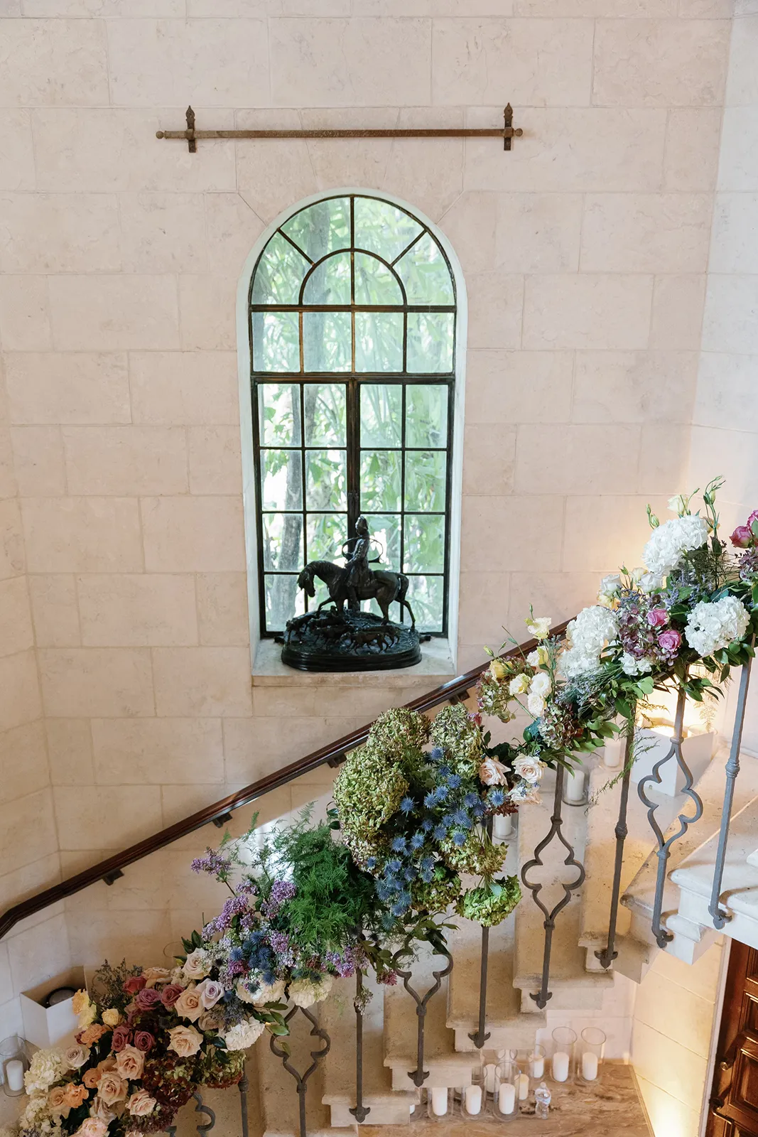 Floral installation lining a grand staircase at a Fisher Island wedding venue