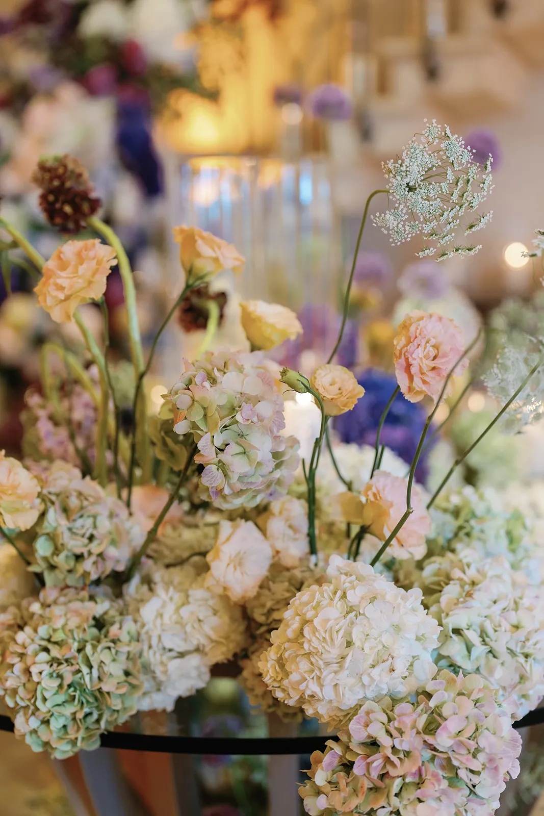 Close-up of pastel floral centerpiece with hydrangeas and roses styled for a wedding reception