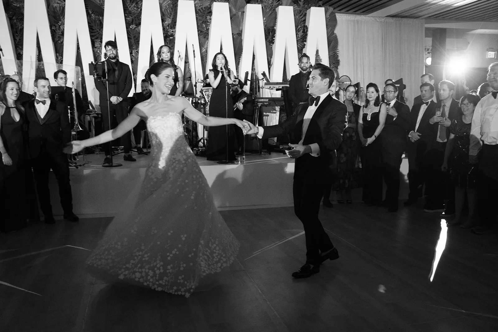 Bride and groom dancing together during their wedding reception with live band at the Miami Beach EDITION