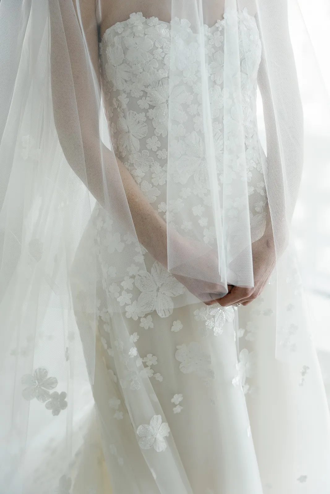 Close-up of lace wedding dress and veil details as the bride gets ready at the Miami Beach EDITION