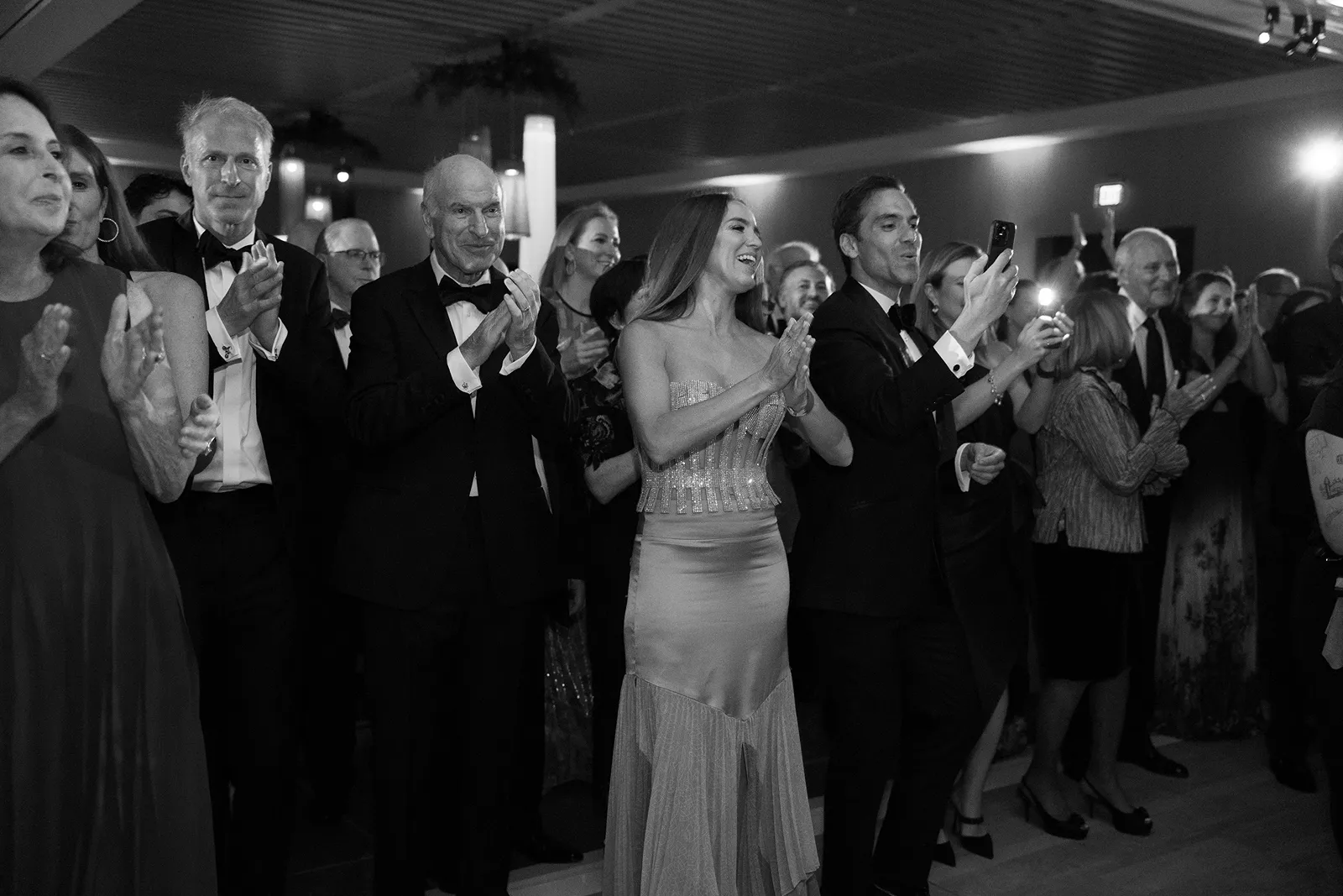 wedding guests cheering and clapping hands during wedding couple entrance