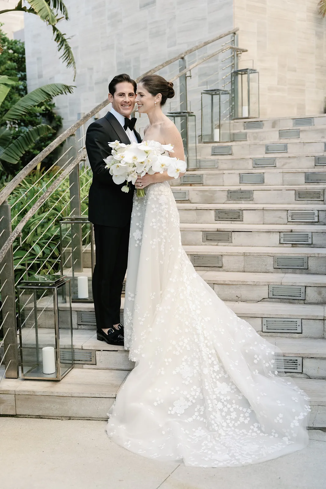 Bride and groom posing together on a modern stone staircase during their Miami Beach EDITION wedding
