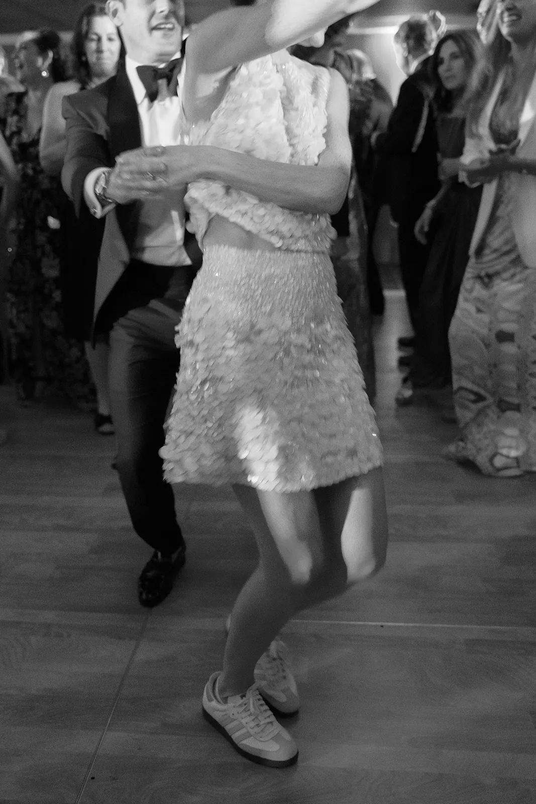 Bride and groom dancing together on a crowded dance floor during the wedding celebration