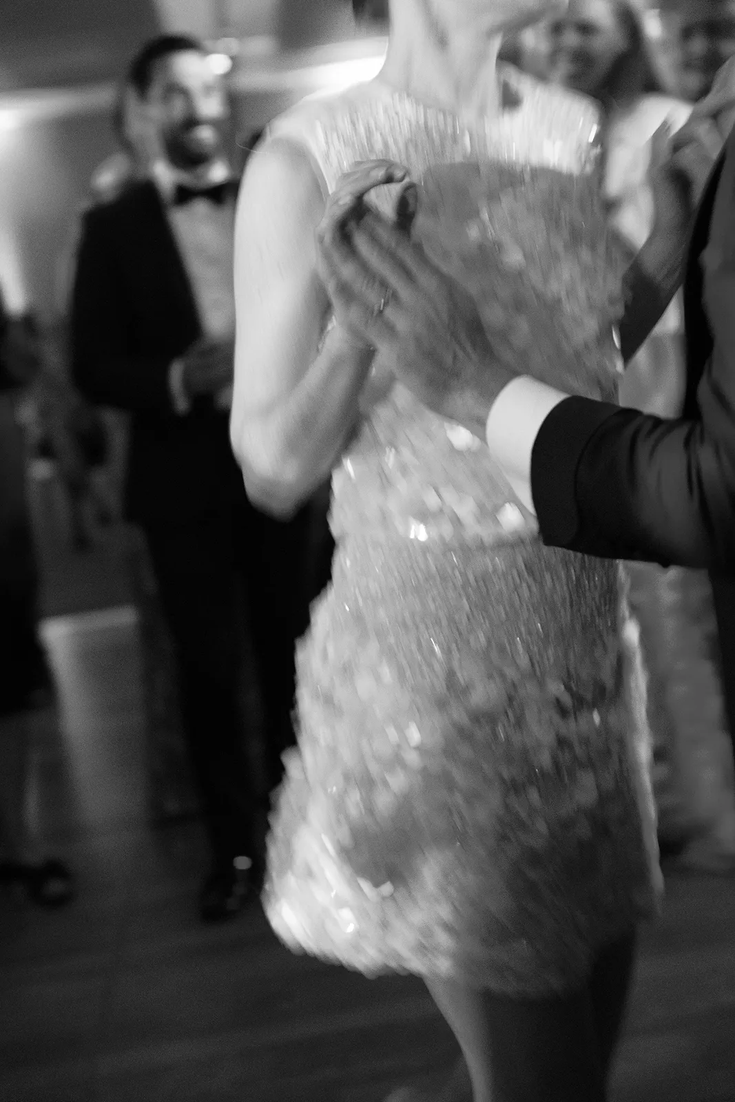 Close-up of the bride dancing with a guest during an energetic moment on the dance floor