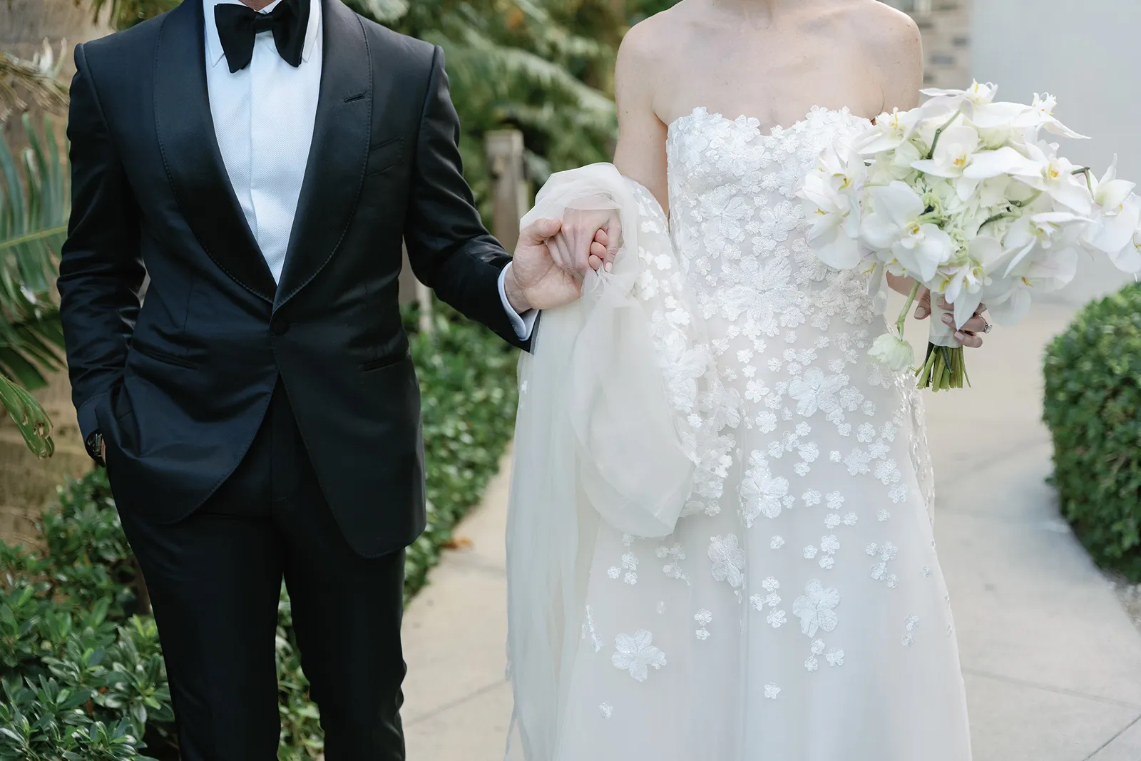 Bride and groom holding hands during portraits at The Miami Beach EDITION