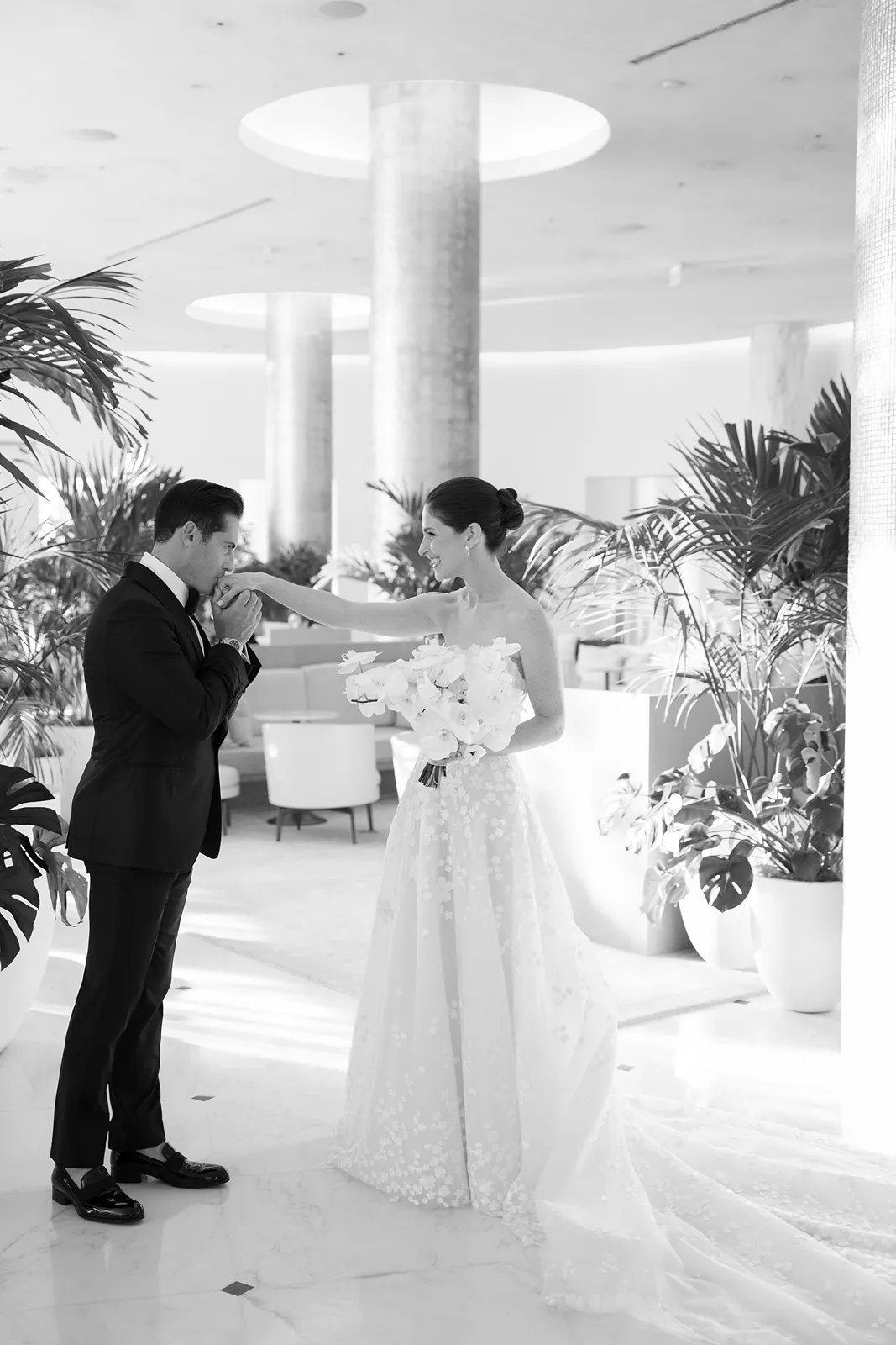 Bride walking toward the reception space with her wedding dress flowing behind her
