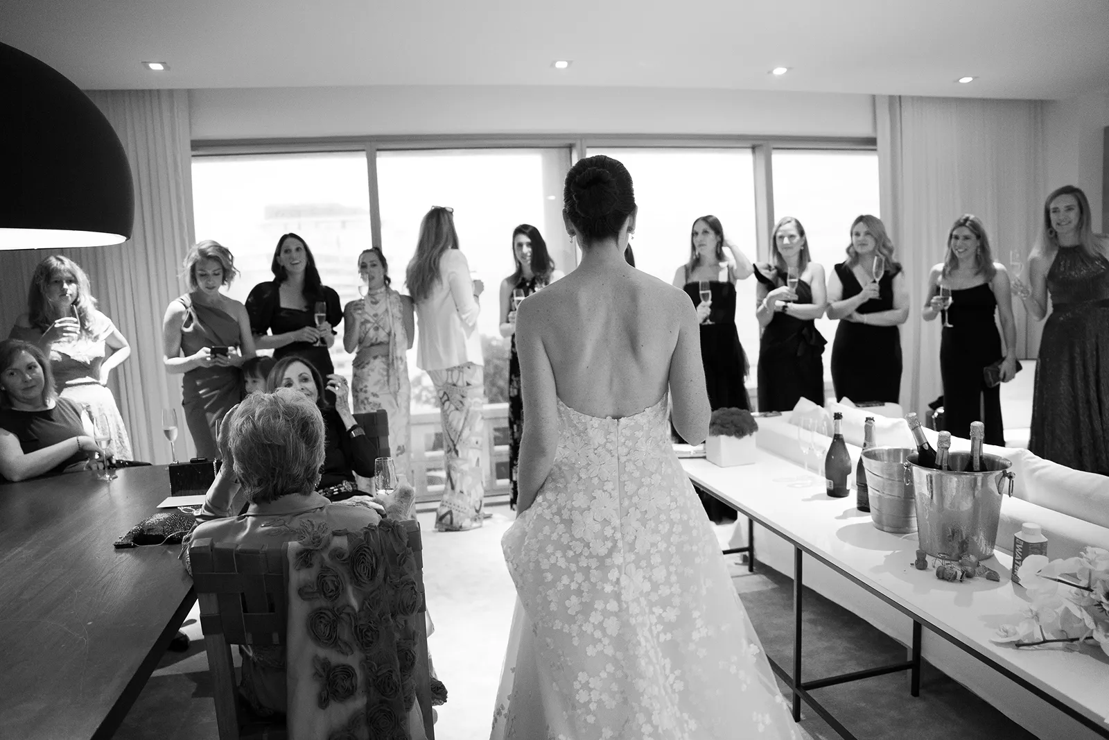 Bride standing in front of her closest friends during an intimate getting ready moment before the ceremony