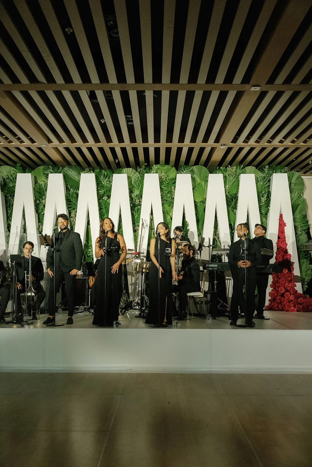 Live wedding band performing on stage during the evening reception celebration