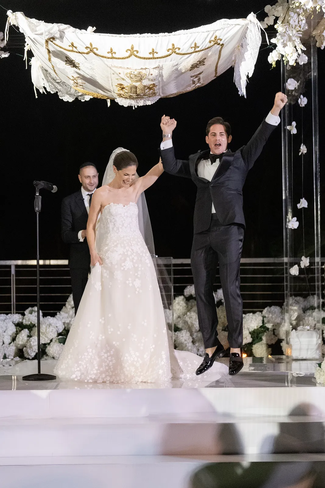 Bride and groom celebrating beneath the chuppah as they conclude their wedding ceremony at The Miami Beach EDITION