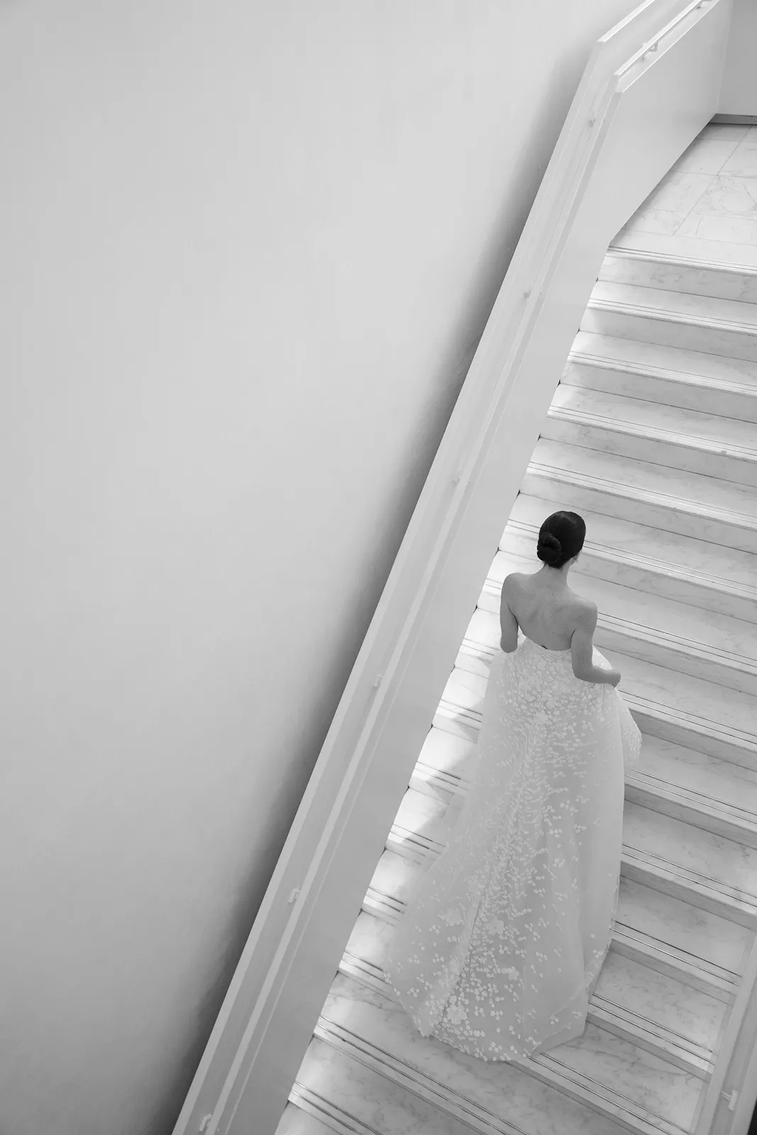 Bride walking down a modern white staircase during wedding portraits at The Miami Beach EDITION