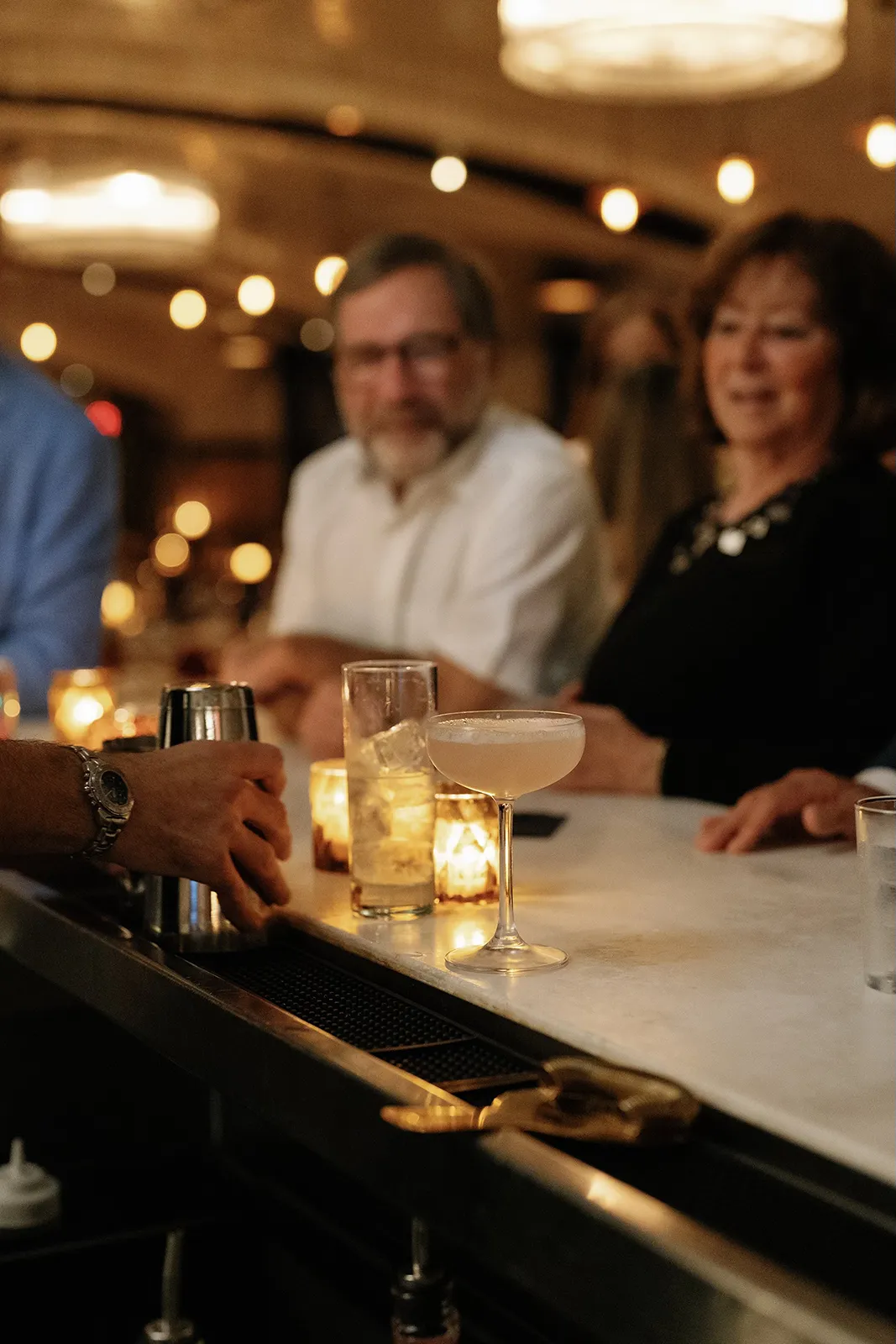 Bartender preparing cocktails at the bar during an intimate rehearsal dinner