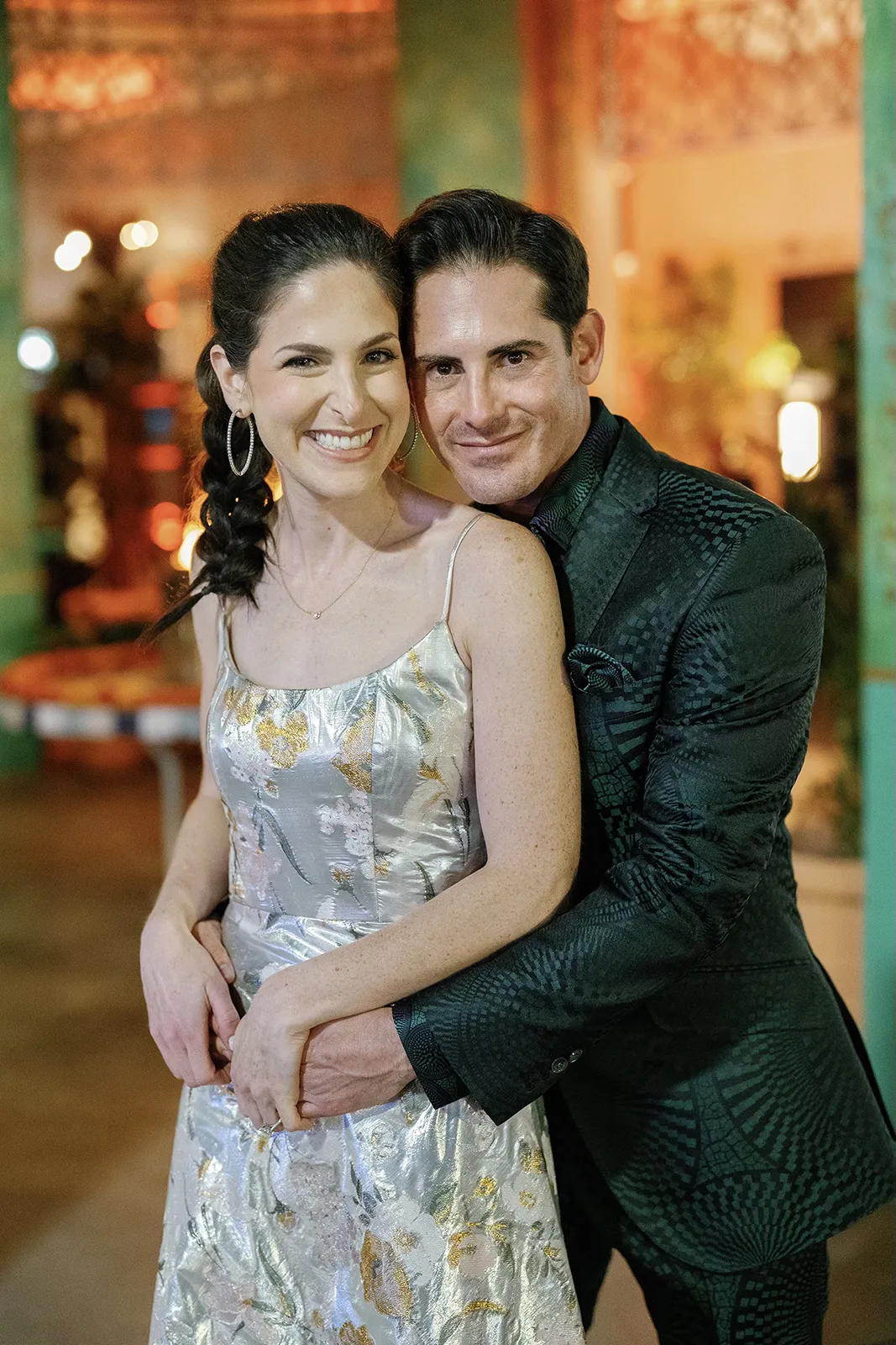Bride and groom smiling and embracing during an intimate rehearsal dinner portrait