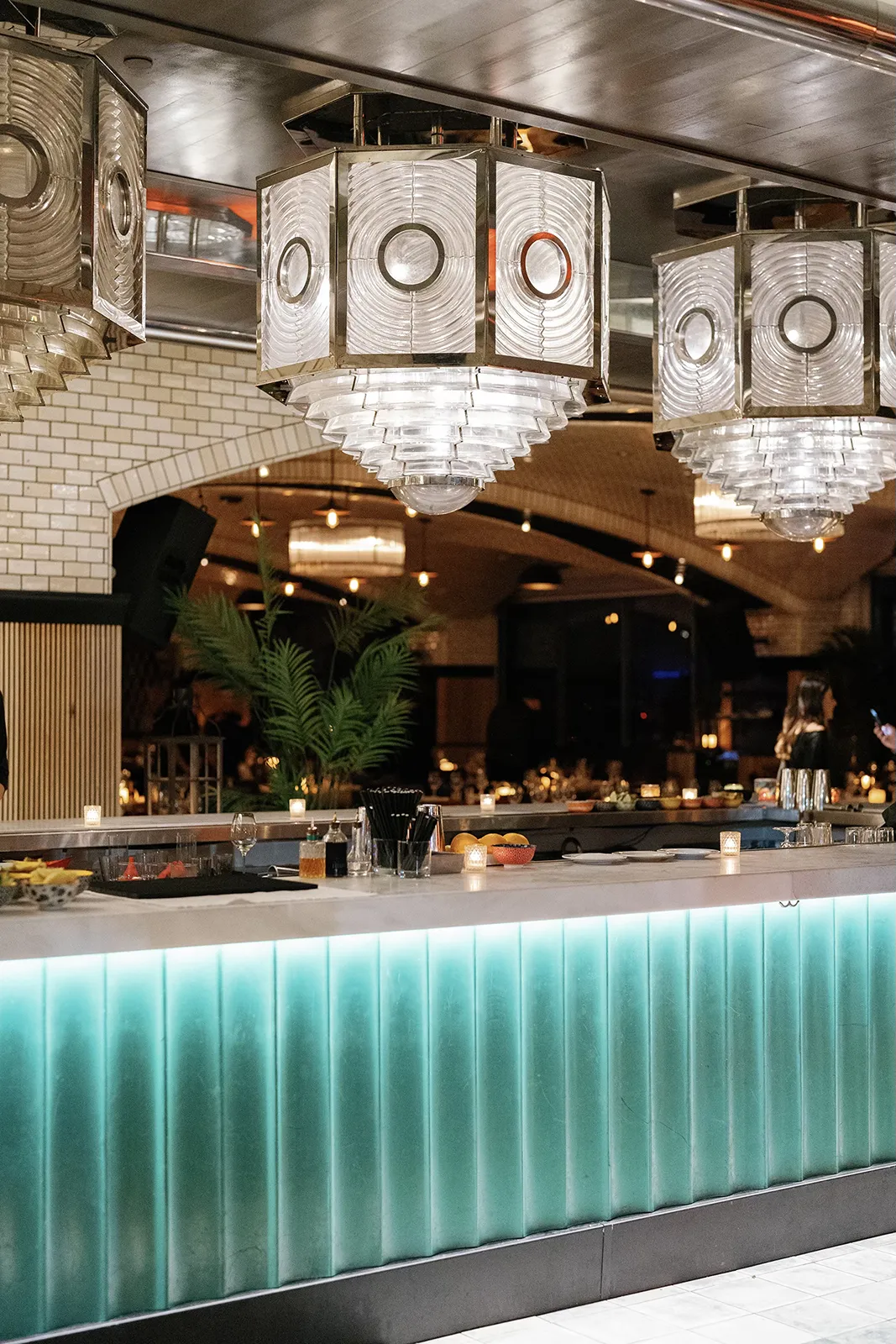 Stylish bar setup with glowing counter and modern lighting during the rehearsal dinner