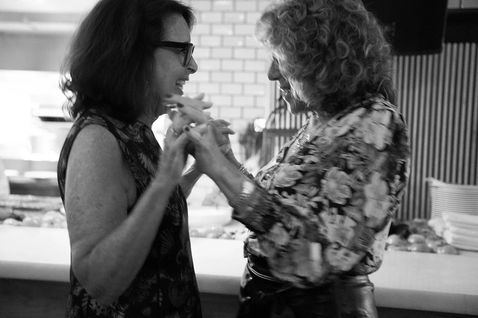 Two guests dancing together during a lively rehearsal dinner at Hasalon Miami Beach
