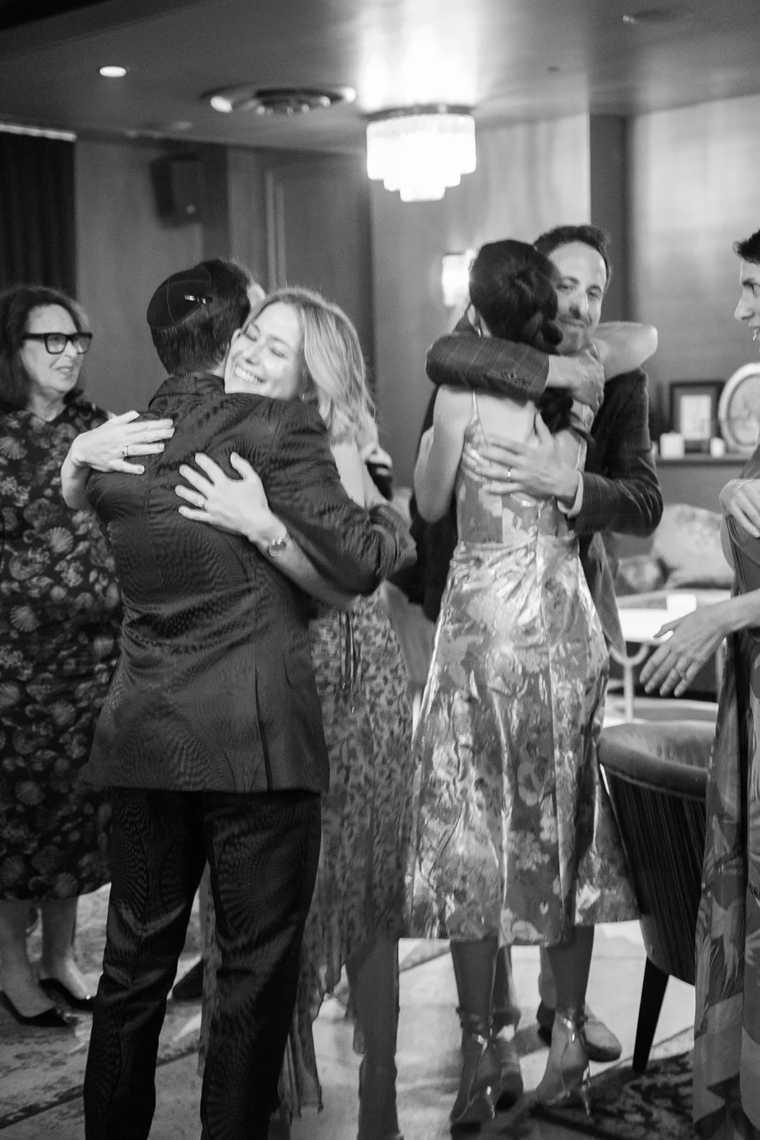 Emotional hugs shared among guests at a rehearsal dinner at Hasalon