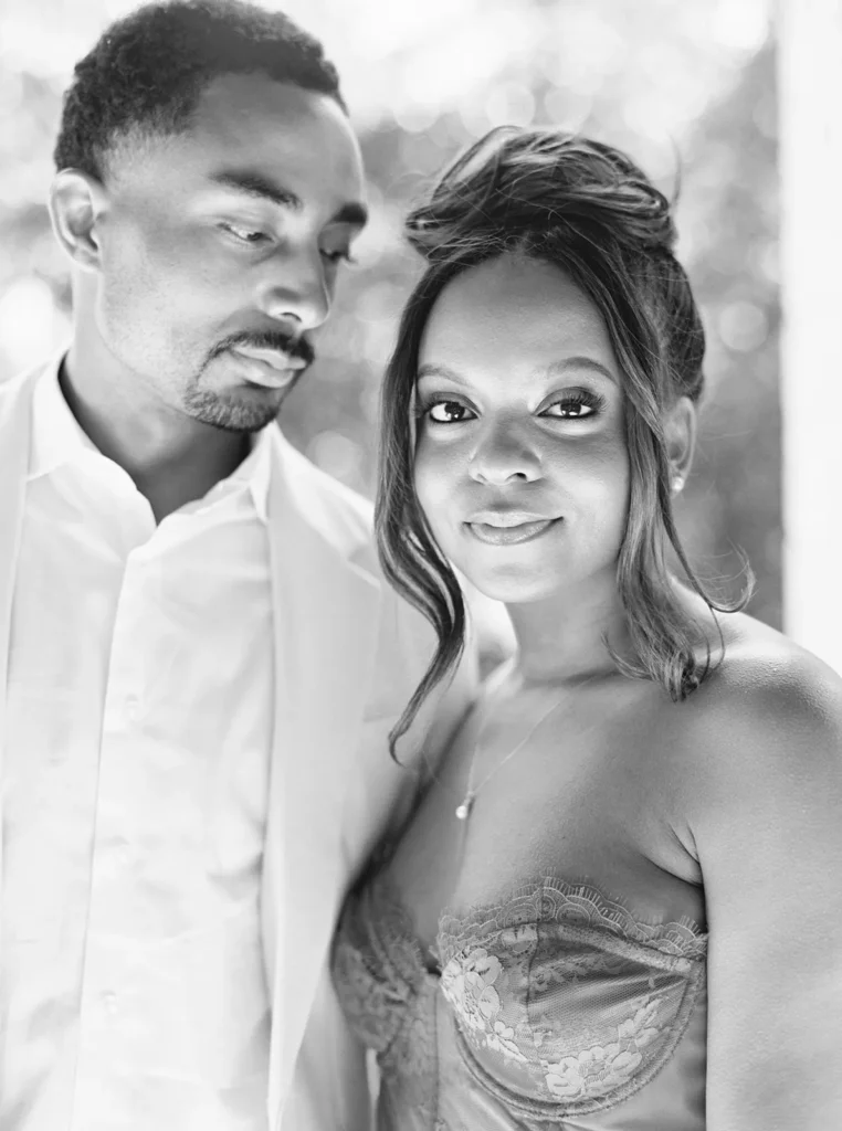 bride looking at the camera while groom observes his bride to be