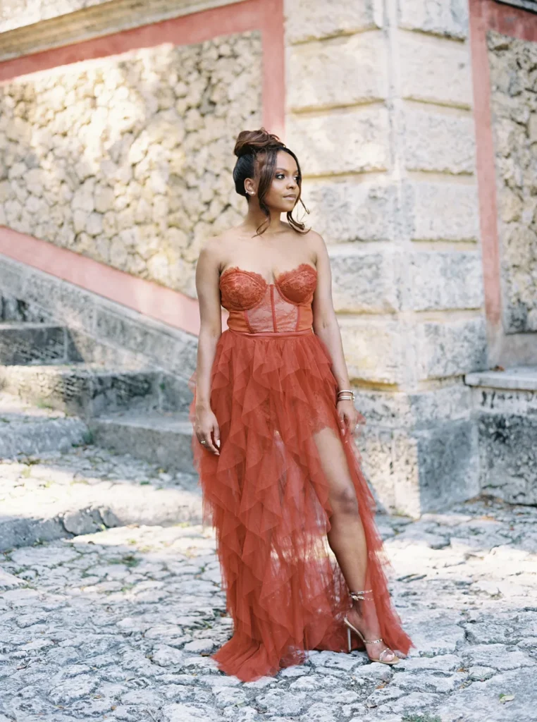 bride posing with red dress in Vizcaya during engagement session