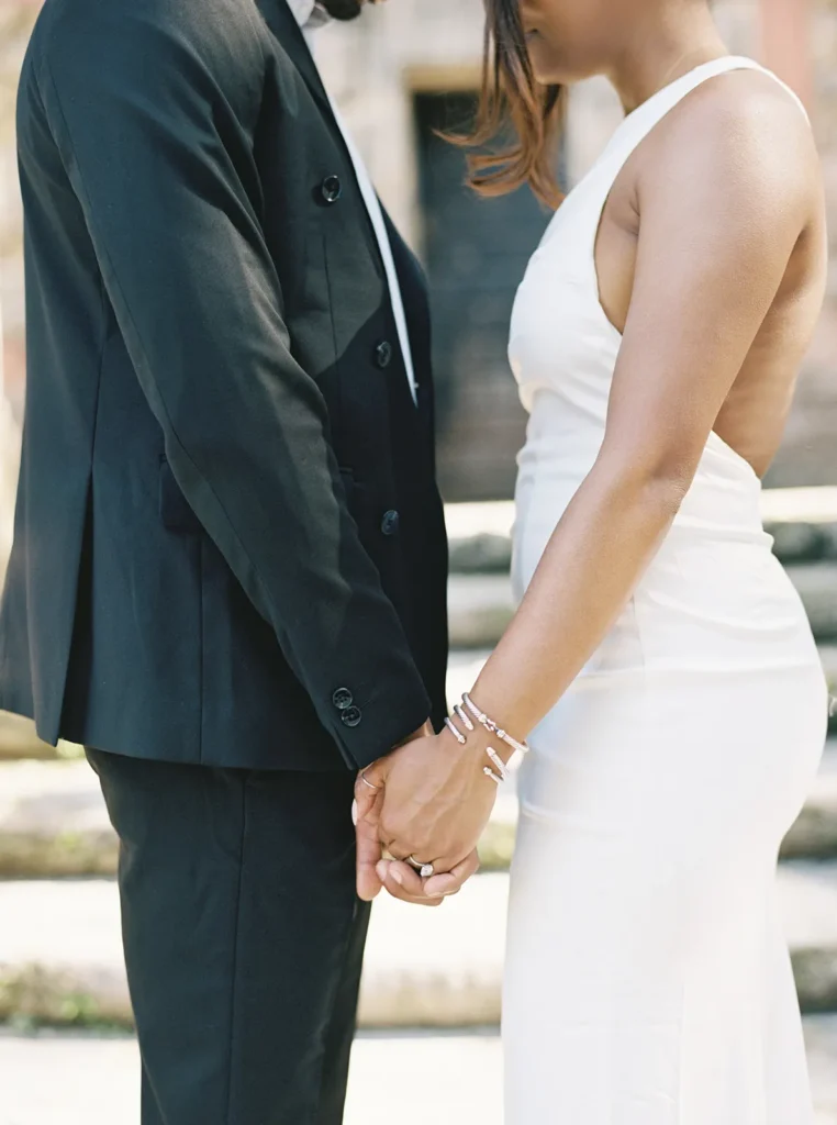 close up of couple facing each other and holding hands