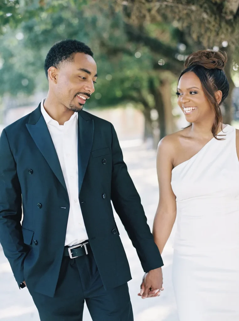 couple exchanging laughter as they walk through the gardens