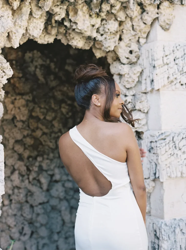 back of the bride showcasing her low back dress