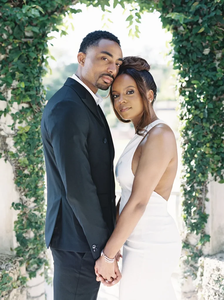 a classic engagement couple portrait under a green vine in vizcaya museum and gardens
