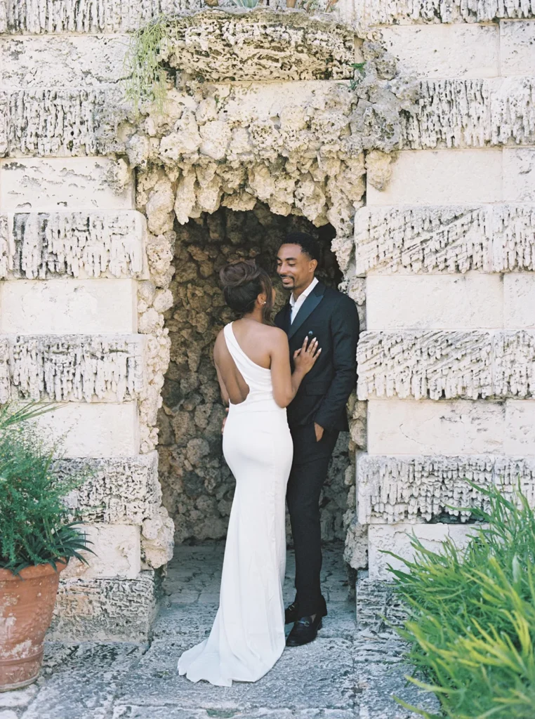 couple under a coral archway in vizcaya museum