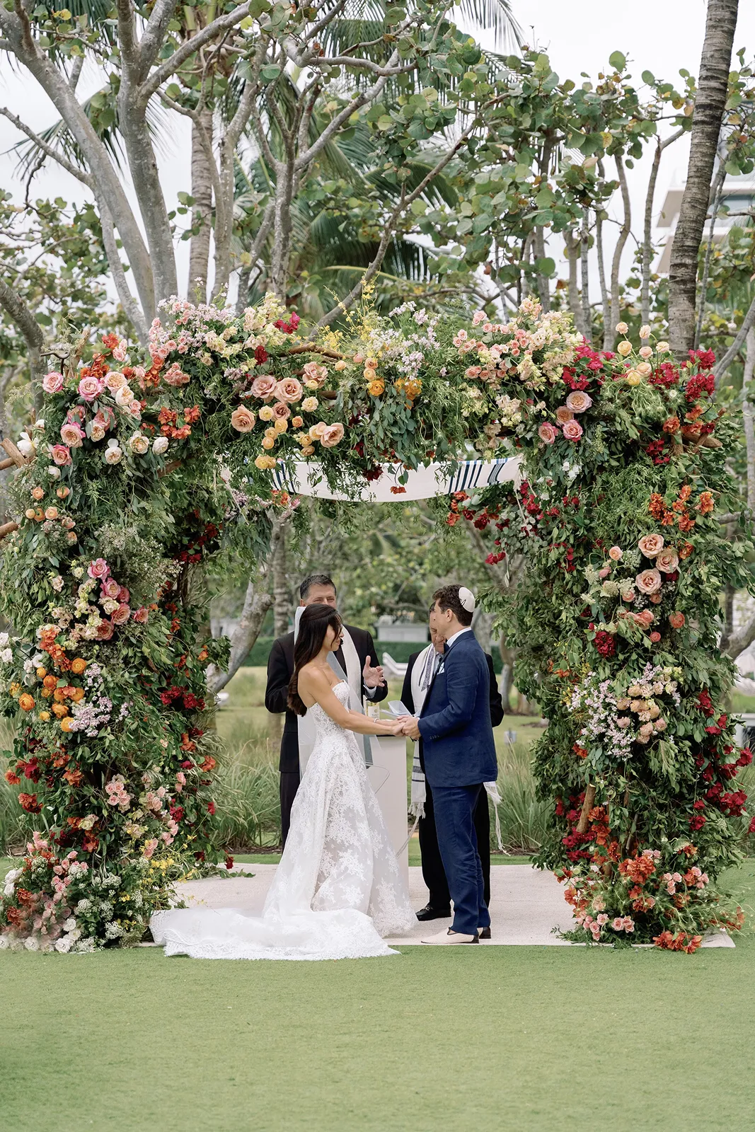 bride and groom holding hands during their wedding vows
