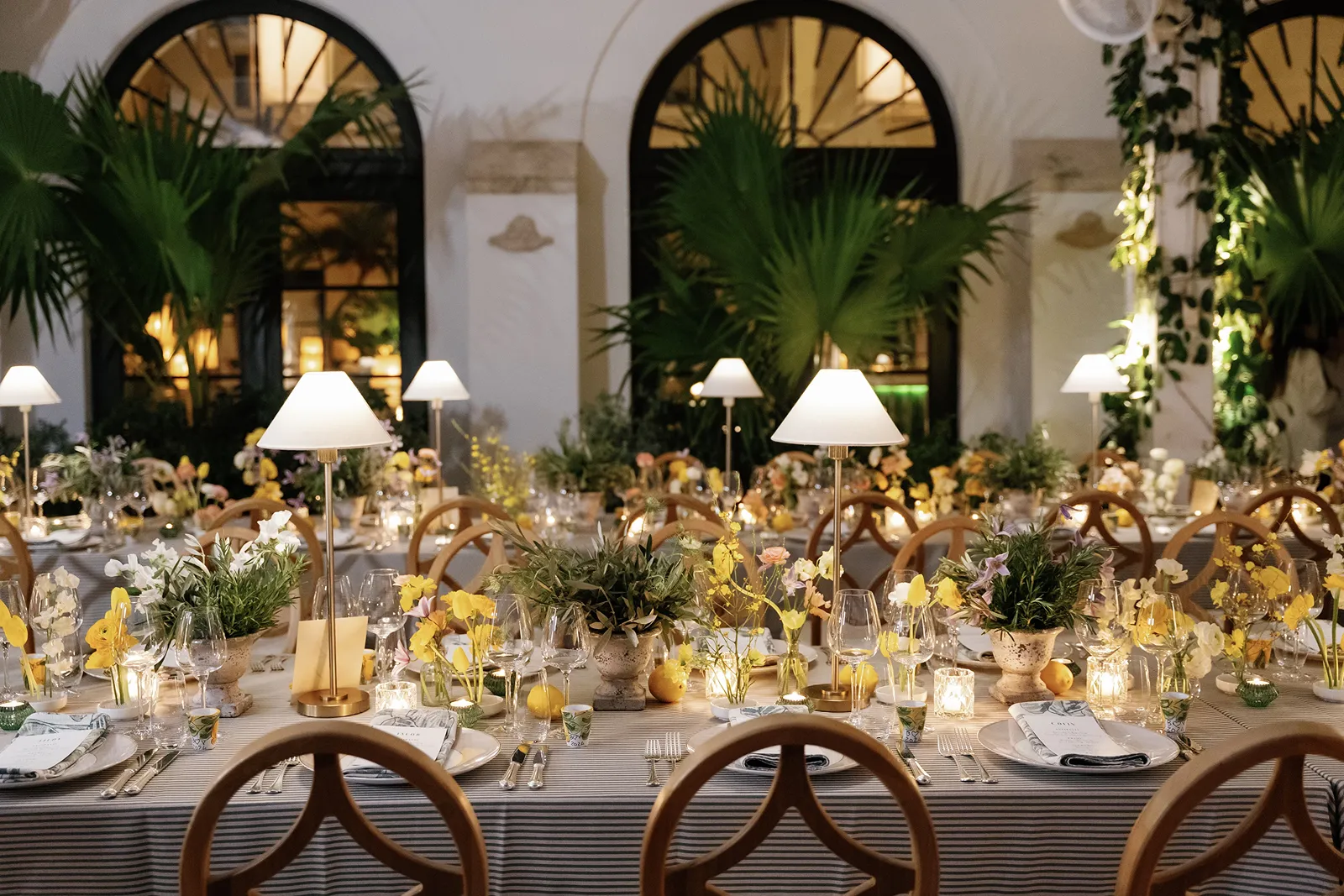wedding reception decorations of yellow and green flowers and lamps
