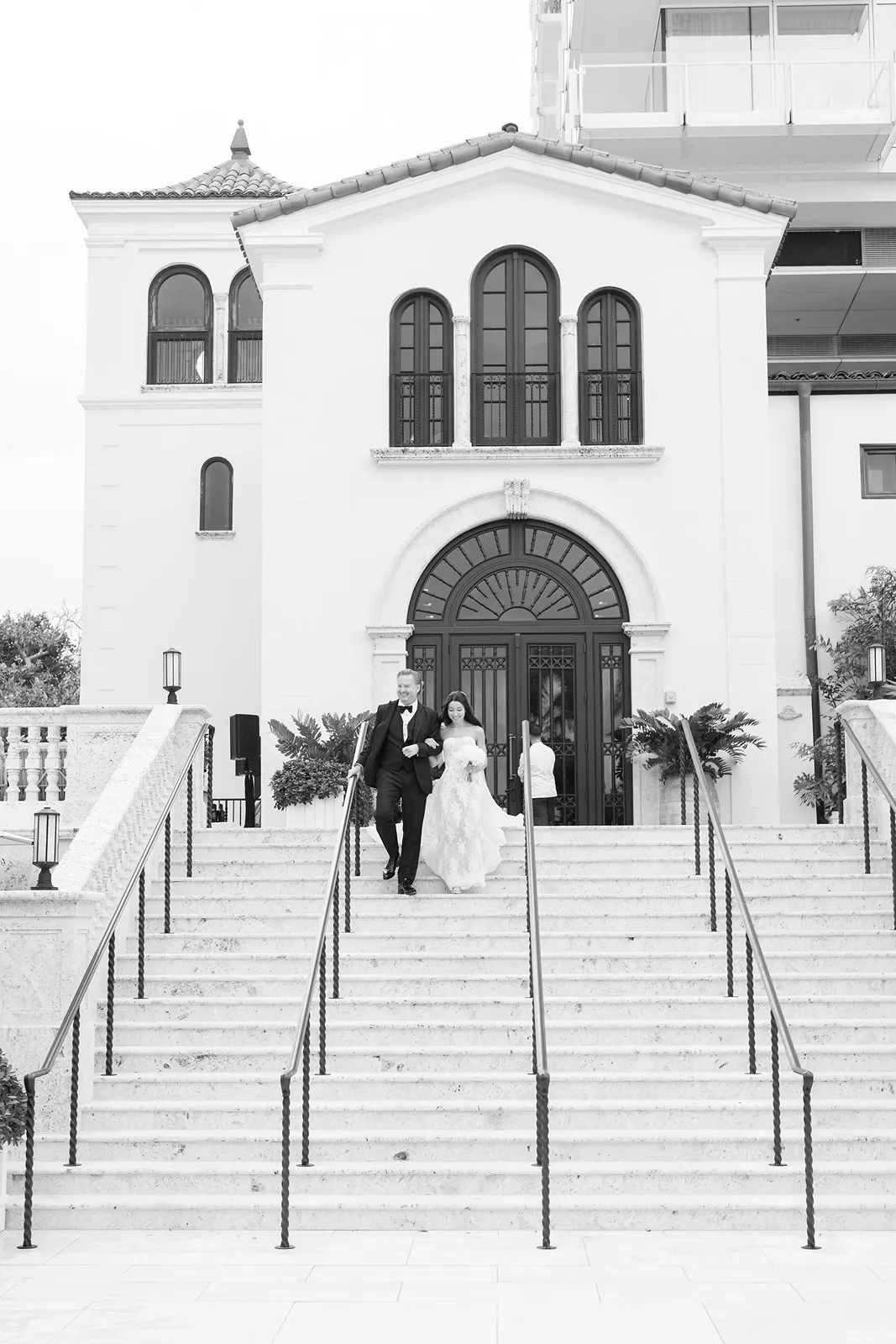 bride and groom coming down the stairs to walk down the aisle for ceremony
