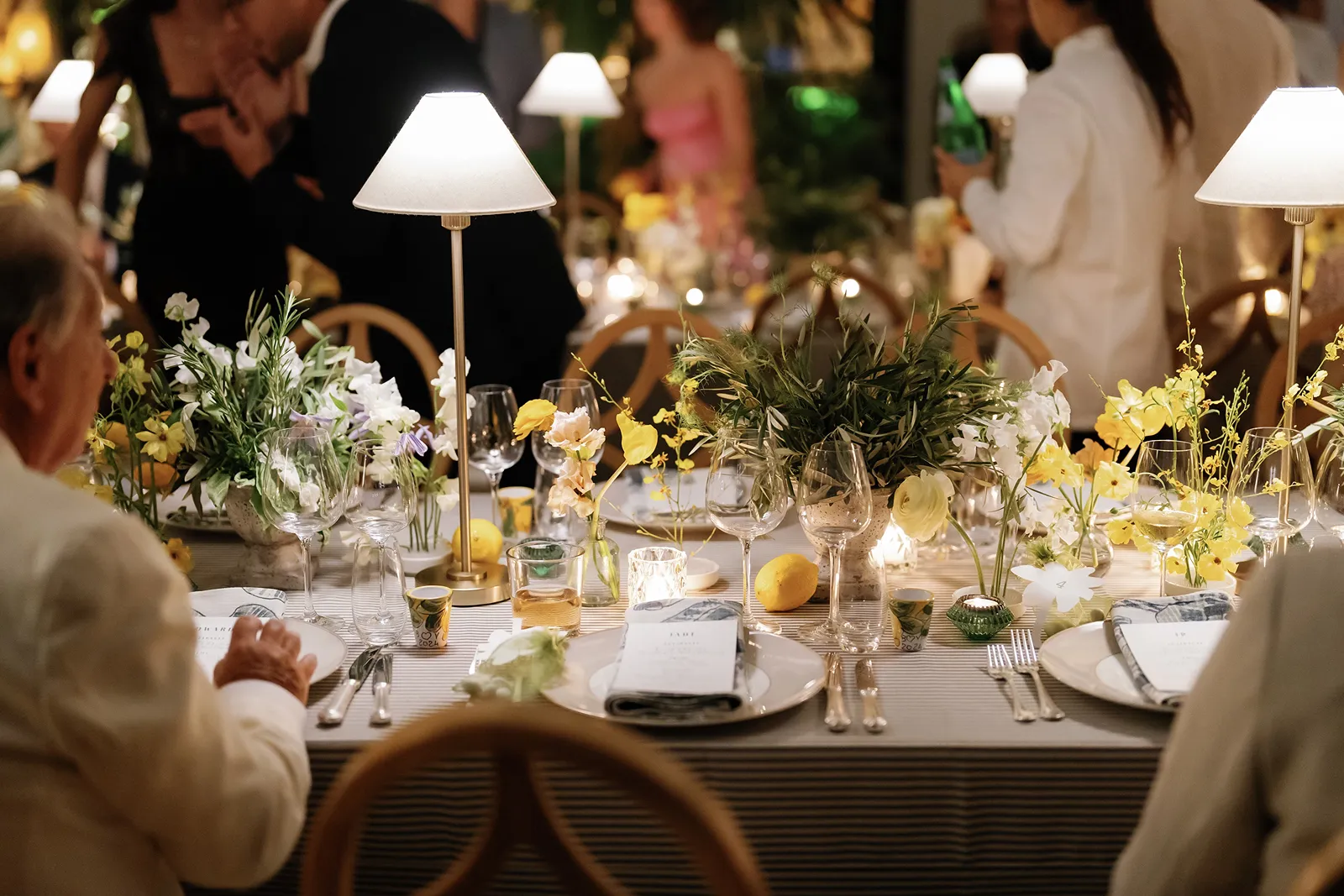 lemons and yellow flowers along the reception tables